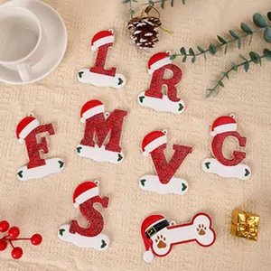 Group of festive red and white resin Christmas letter ornaments with Santa hats