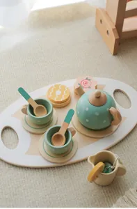 Detailed view of a pastel wooden tea set with polka dot teapot and cups on a tray
