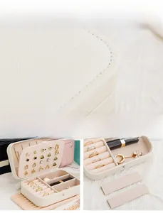 Detailed macro view of cream faux leather jewelry box with earring and ring storage