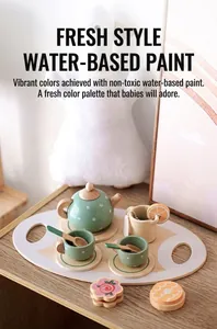 Wooden children's tea set with mint green polka dot teapot and cups on a tray