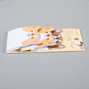 Seitenansicht süßer Shiba Inu Tier-Haftnotizen auf einer gelben Kartonunterlage.