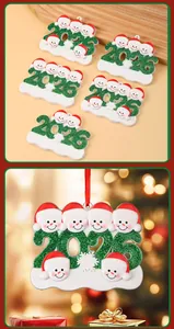 Close-up of 2026 family snowman Christmas resin ornament with glitter detail.