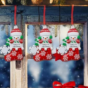 Hand-painted resin snowman in a Christmas stocking ornament for Baby's 1st Christmas