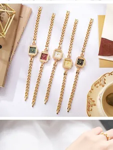 Detailed view of five vintage square quartz watches with elegant gold bracelet straps.