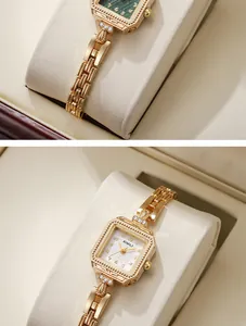 Close-up of elegant gold square quartz watch with textured dial and bracelet strap