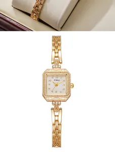 Close-up of elegant gold square quartz watch with decorative textured bezel and chain strap