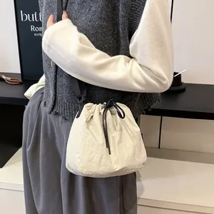 Lightweight nylon drawstring bucket bag for women, stylish crossbody shoulder bag.