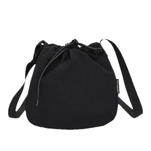 Versatile lightweight black nylon drawstring bucket bag for sports and daily use.