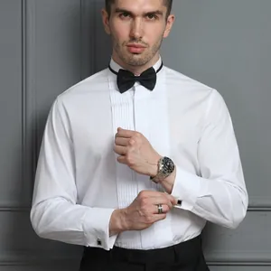 Close-up detail of white pleated tuxedo shirt with black bowtie for formal events