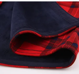 Macro view of warm navy fleece lining inside a red plaid flannel shirt jacket