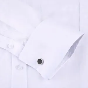 Men's white long sleeve French cuff shirt with elegant black round cufflinks.