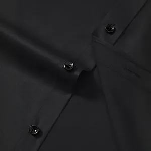 Close-up of black non-iron long sleeve men's business shirt with button detail