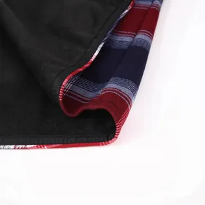 Close-up of men's warm plaid flannel shirt featuring thick black inner fleece lining