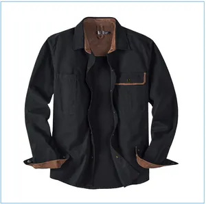 Detail of black cotton workwear shirt featuring brown corduroy collar and cuff accents