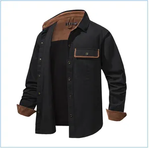 Detail view of men's black cotton work shirt with brown corduroy collar and cuffs.
