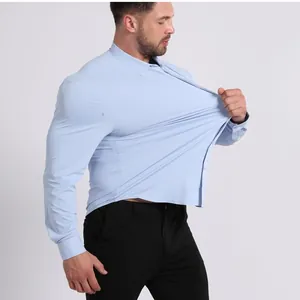Detailed shot of a man stretching a light blue high-elasticity non-iron long sleeve shirt.