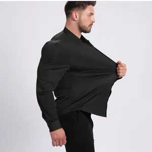 Detail shot showing high elasticity of men's non-iron black stretch long sleeve shirt.