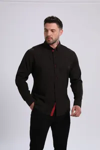 Detailed view of men's black long-sleeved shirt with red inner collar accents.