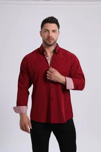 Detail of burgundy men's dress shirt with contrast patterned cuffs and inner collar.