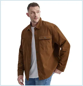 Detailed view of a men's brown cotton workwear shirt featuring double flap chest pockets.