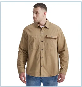 Close-up of men's khaki work shirt featuring corduroy trim on pocket and button fasteners