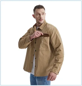 Close-up of men's khaki cotton work shirt showing corduroy contrast pocket detail.