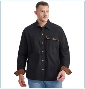 Detail of black cotton work shirt featuring brown corduroy contrast on cuffs and pocket.