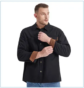 Detail view of men's black cotton work shirt featuring brown corduroy contrast cuffs