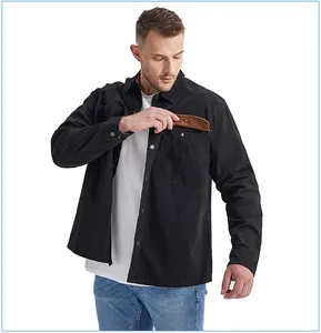 Detail of men's cotton work shirt featuring corduroy contrast pocket flap with snap button
