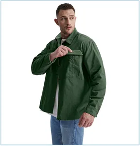 Close-up of the light green corduroy pocket flap on a dark green cotton workwear shirt.