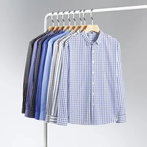 Collection of men's long-sleeve plaid and striped stretch shirts on a white clothing rack