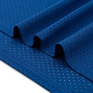 Close-up macro detail of blue mesh basketball jersey fabric with breathable texture