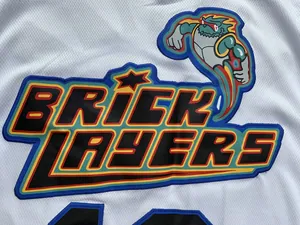 Detailed macro view of embroidered Brick Layers logo on white mesh basketball jersey