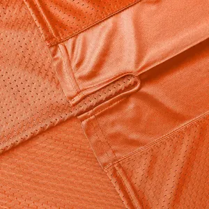 Close-up of breathable orange mesh fabric and durable stitching for American football jersey