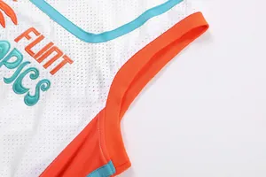 Close-up detail of Flint Tropics embroidery on high-quality white mesh retro basketball jersey