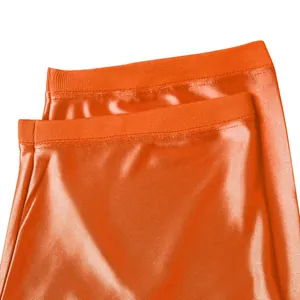 Macro view of orange football jersey fabric detailing the ribbed collar and mesh weave