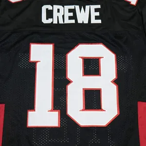 Detailed macro view showing the embroidered name CREWE and number 18 on a black football jersey