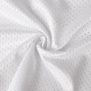 Macro view of breathable white mesh fabric texture used in sports football jerseys.