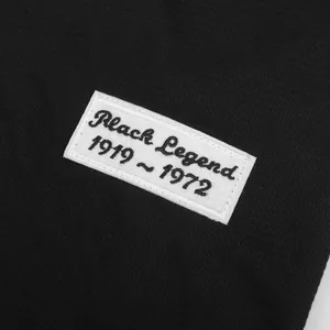 Close-up of Black Legend 1919-1972 embroidered patch on black vintage baseball jersey.