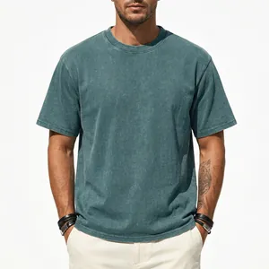 Close-up of vintage washed teal cotton T-shirt showing distressed fabric texture and relaxed fit