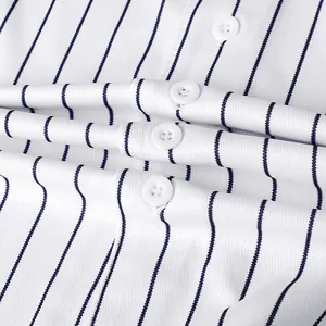 Close-up of white baseball jersey fabric with navy blue stripes and buttons