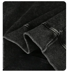 Detailed view of heavy washed black sweatshirt fabric with premium ribbed cuff finishing