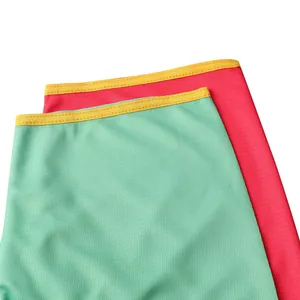 Close-up detail of breathable mesh baseball jersey fabric with vibrant yellow edge stitching