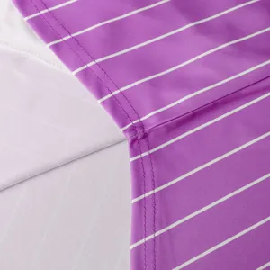 Close-up of purple and white striped baseball jersey fabric with professional stitching detail.