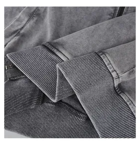 Close-up of heavy cotton washed vintage hoodie showing ribbed cuff and metal zipper texture
