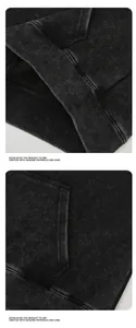Détail macro de la texture délavée et de l'ourlet côtelé d'un sweat à capuche noir premium