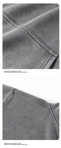 Close-up macro detail of heavy washed grey hoodie showing stitching and premium fabric texture.