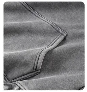 Detailed macro view showing the washed gray texture and stitching of a heavyweight fleece hoodie