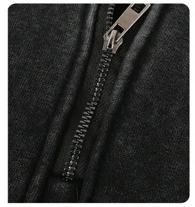 Close-up macro detail of the durable metal zipper on a vintage washed gray hoodie jacket