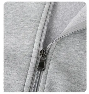 High-quality macro detail of gray fleece fabric texture and smooth metal zipper